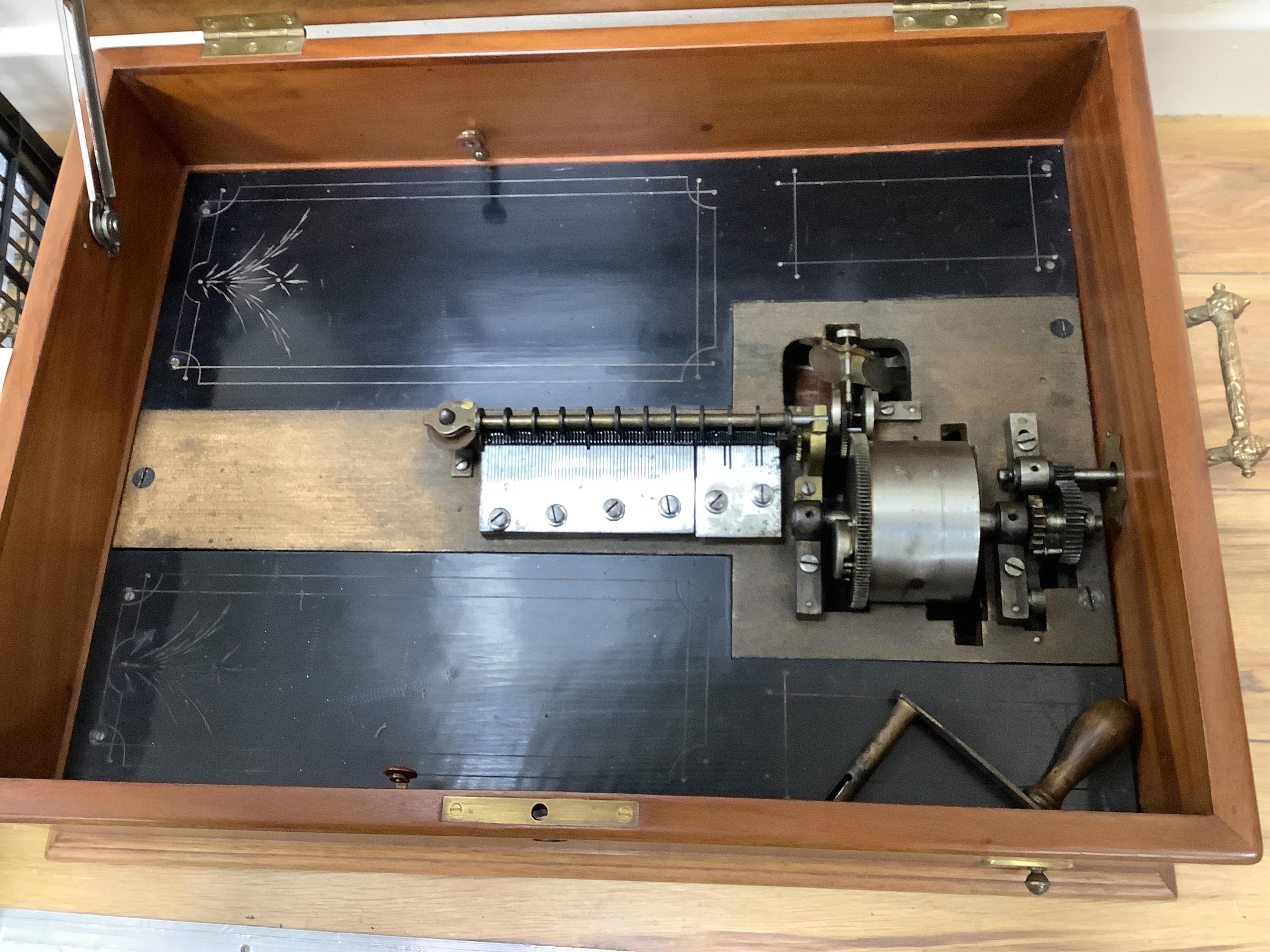 A walnut cased Orphenion, the replacement case is understood to have been constructed from panels from RMS Mauretania, 64cm wide, 49cm deep, 23cm high, with twenty-two 41cm diameter discs. Condition - good.